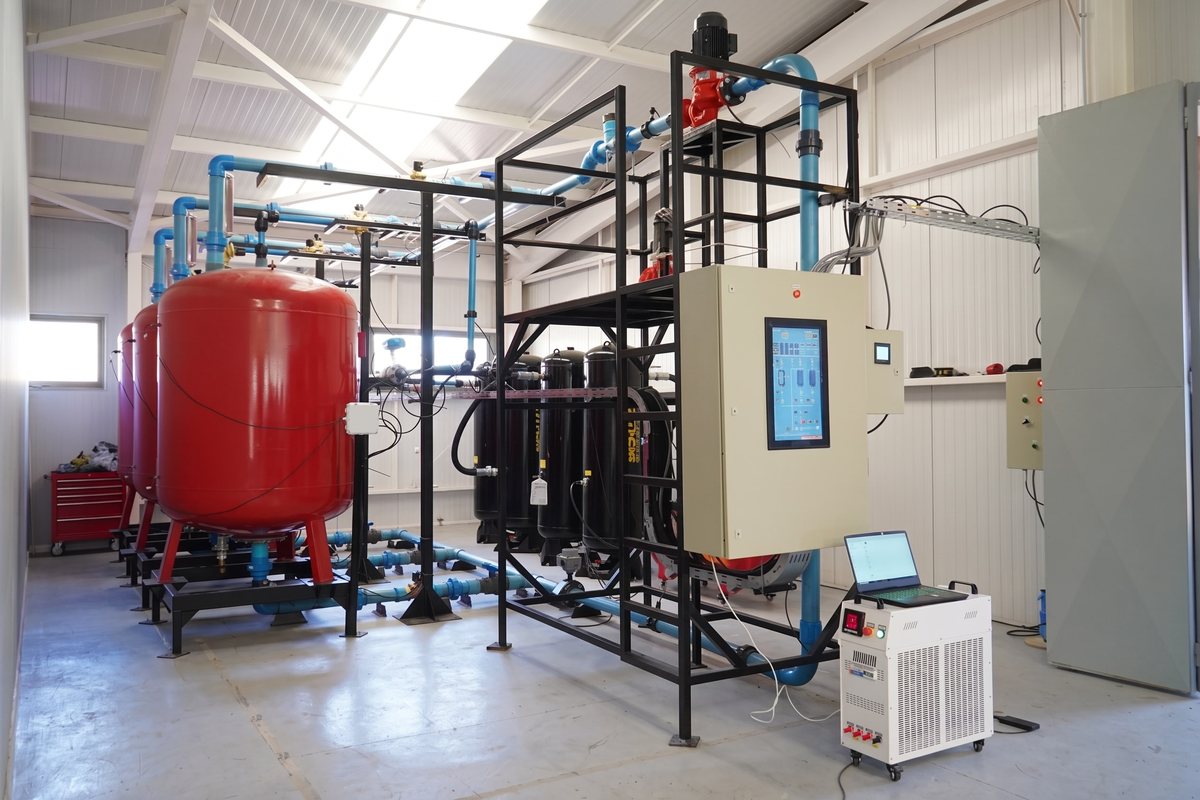 Inside the CHEX facility: pressure tanks, piping and the control panel of the 10 kW working unit